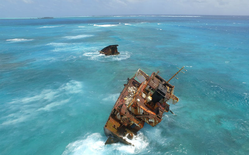 A shipwreck in an ocean taken from a travel drone