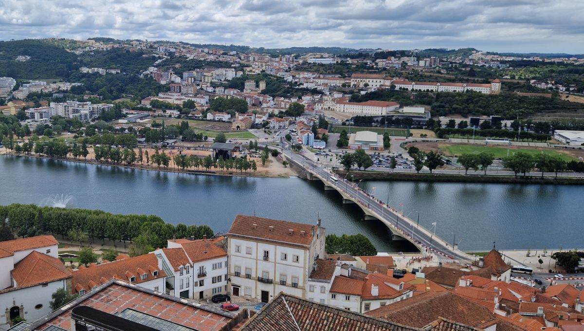 The Ponte de Santa Clara spanning the Mondego River in Coimbra on a cloudy day.