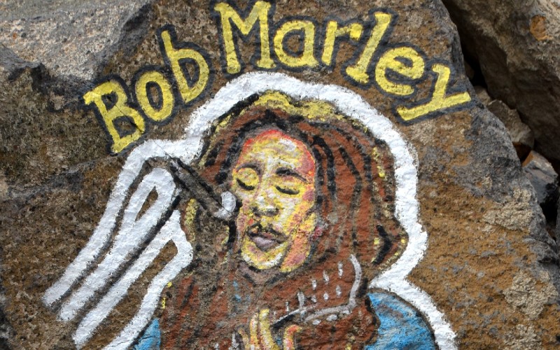 Bob Marley artwork painted on a rock.