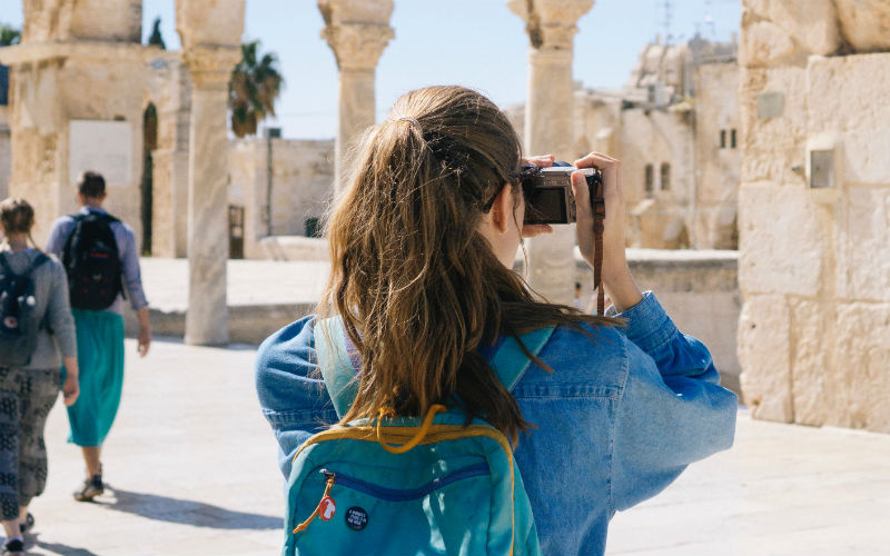 Mujer tomando una foto mientras viaja