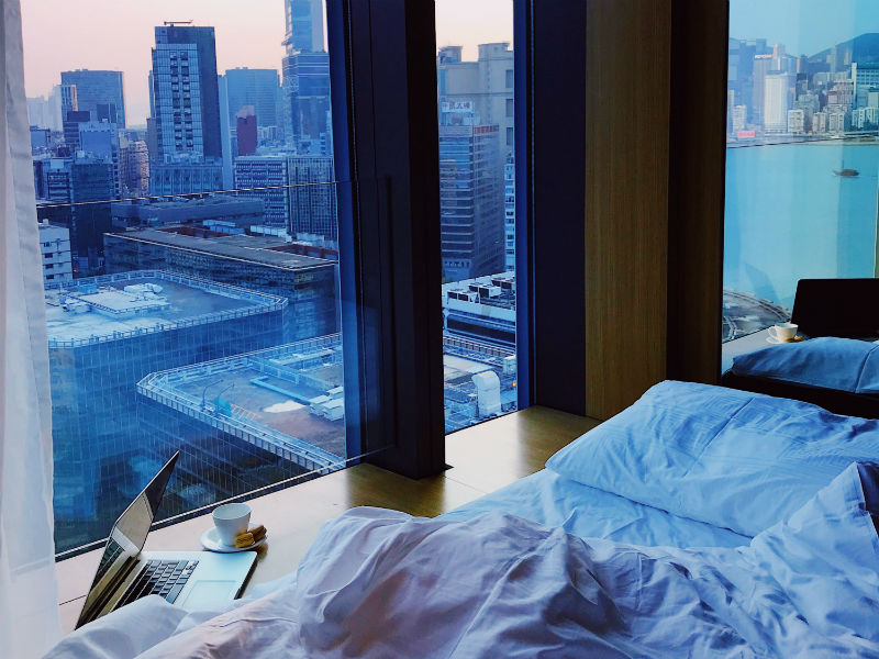 A laptop sat by the window in a hotel room which is not the best thing to do when you are looking for how to keep a laptop safe in a hotel room