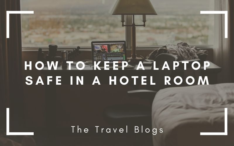 A laptop set on a desk by the window in a hotel room