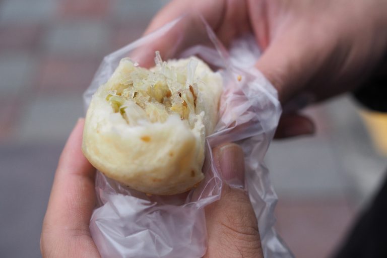 Me eating some dumplings in Taiwan as part of my 2 Days In Taipei Itinerary