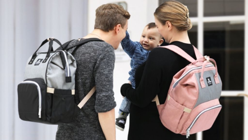 Parents and their baby with traveling backpack