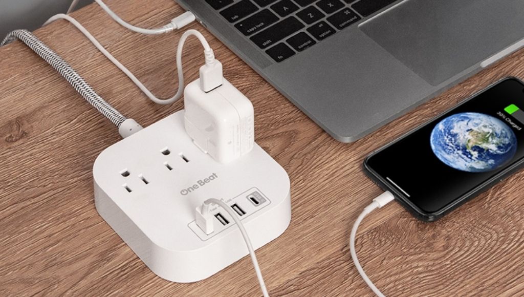 A power strip surge protector connect with smartphones and a laptop