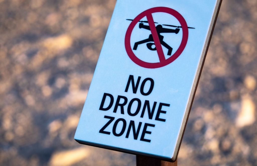 A sign post marking an area it is illegal to fly a drone.