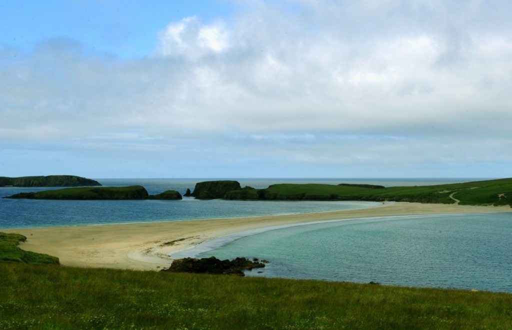 A sandy landbridge known as St Ninian's Beach in Mainland Shetland