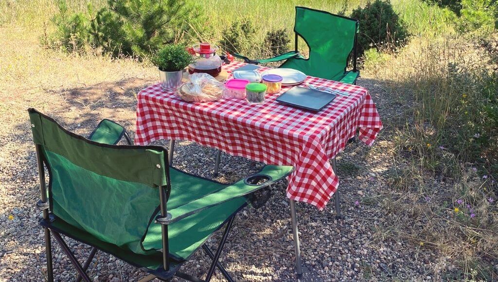 collapsible chairs table and table cloth camping in nature