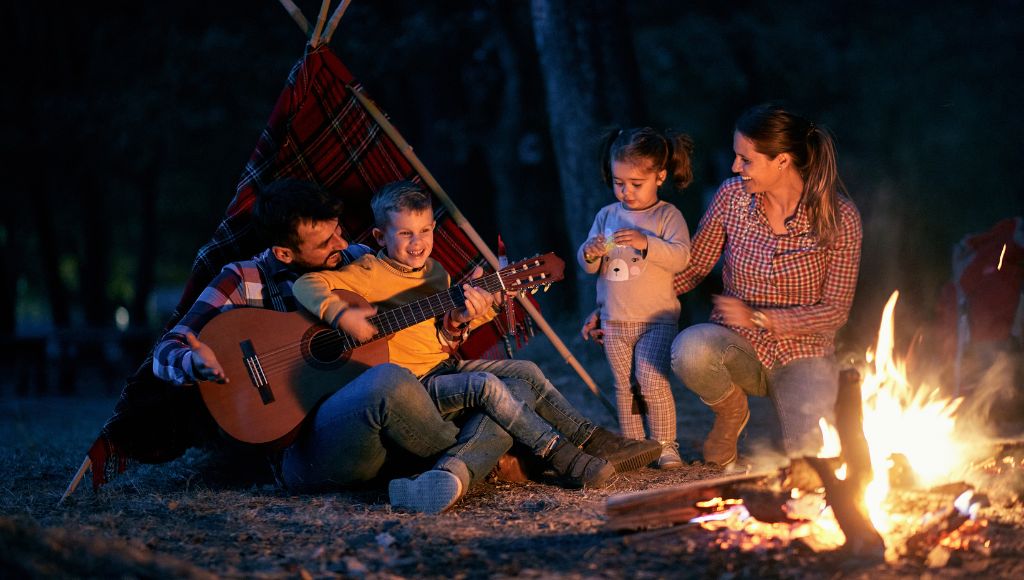 A family enjoying campfire at night