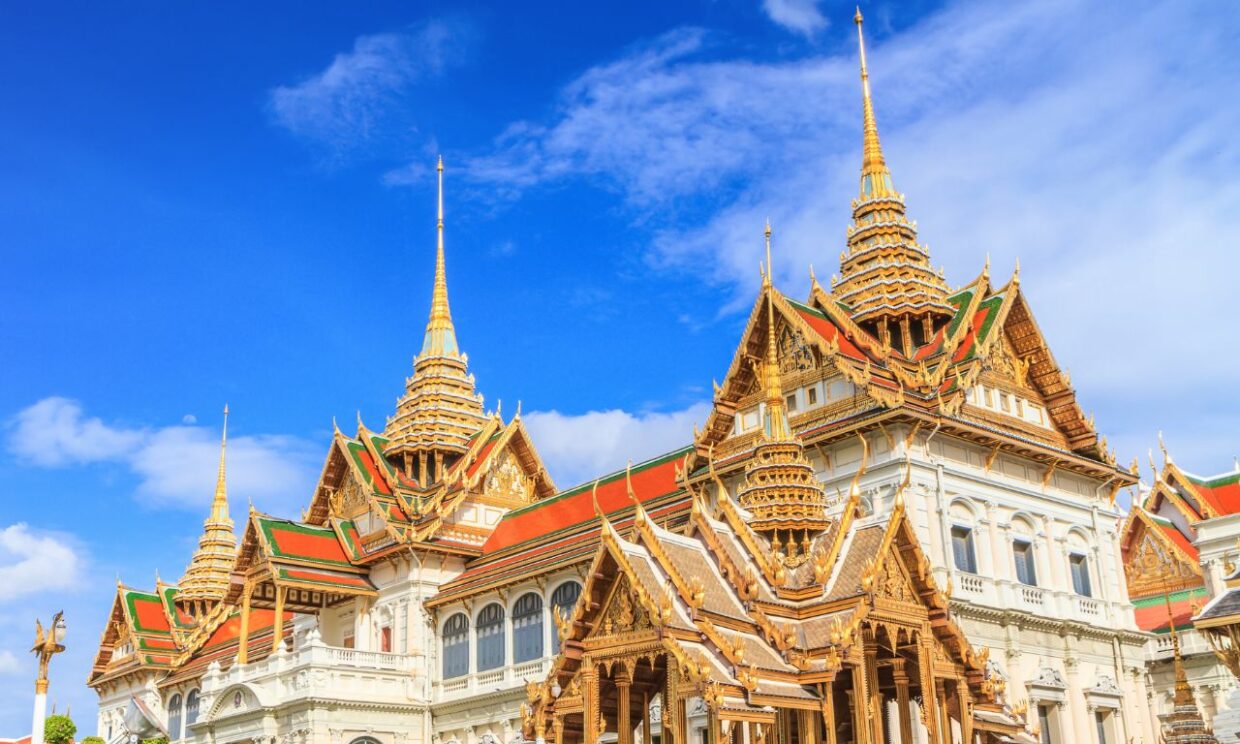 Rooftop of The Grand Palace in Bangkok set against a bright blue sky
