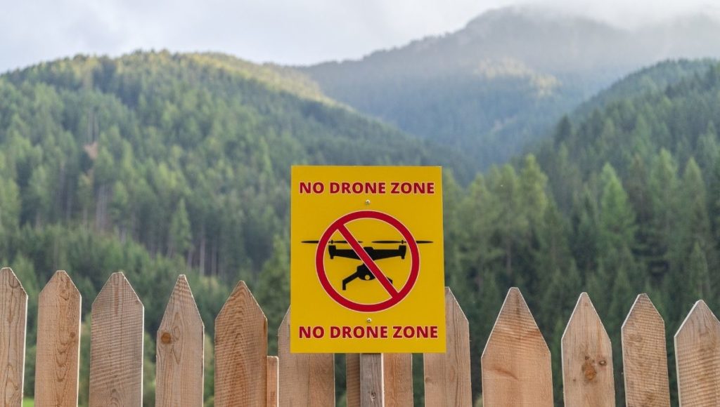A yellow no drone zone signboard outside of the national park