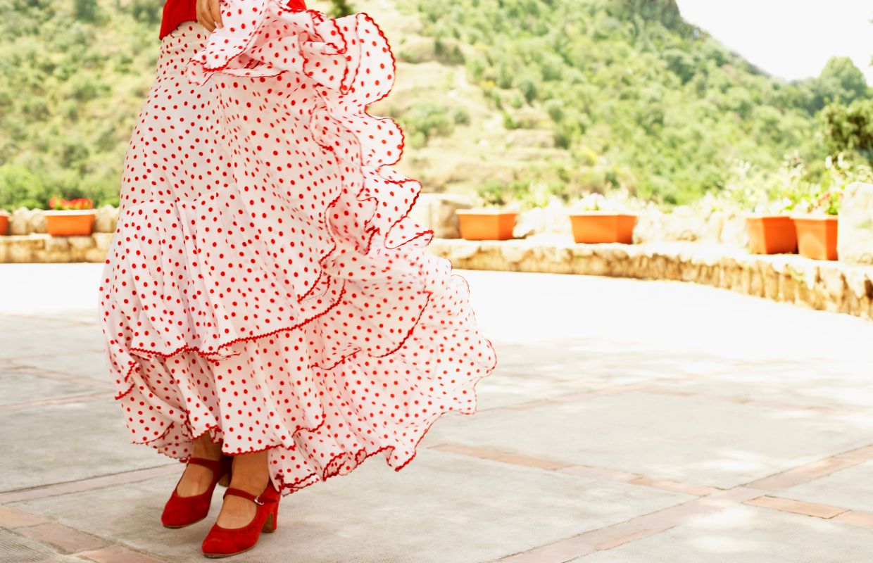 A lady in a traditional red and white flamenco dress