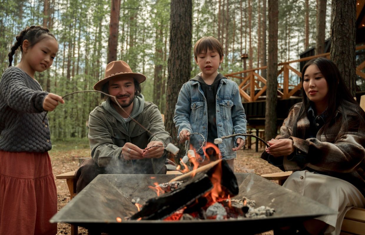 A family roastin marshmallows over camp fire