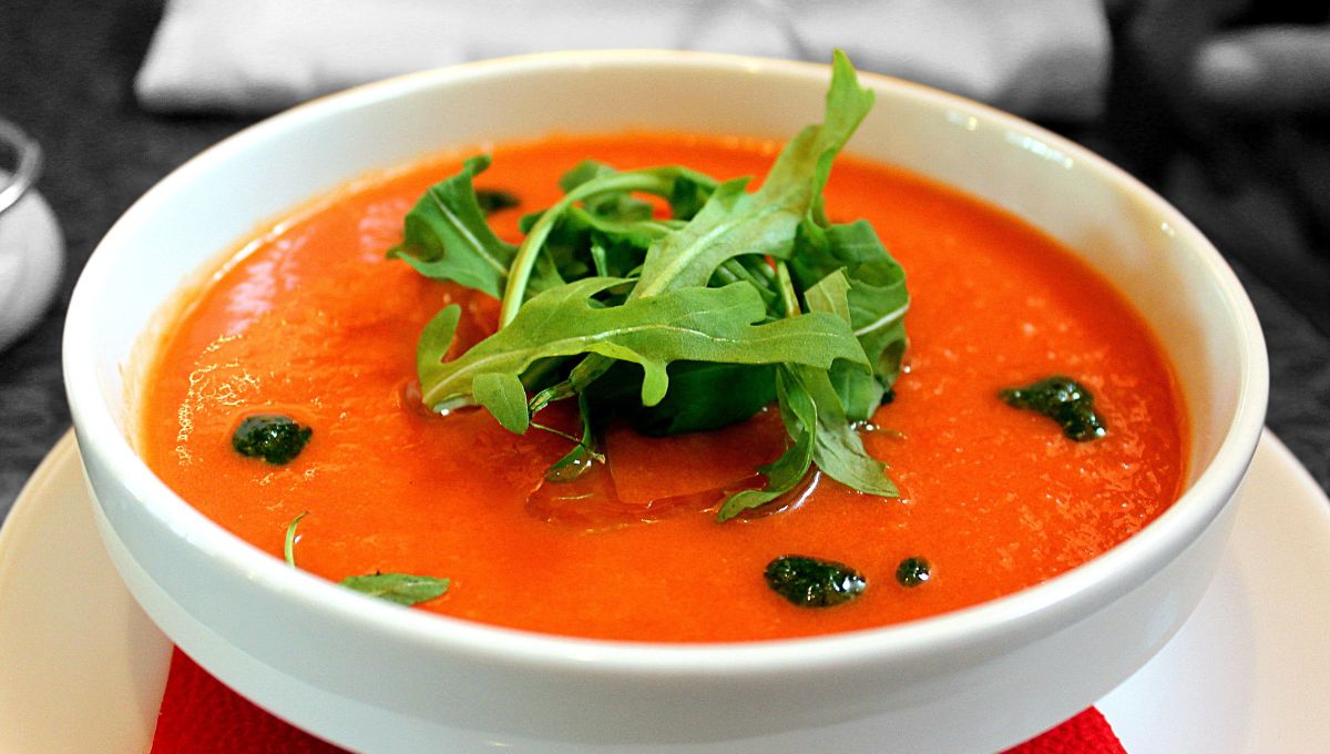 A bowl of chilled Gazpacho topped with some green rocket leaves